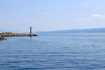Clear sea and small lighthouse on the beach in Split, Croatia.