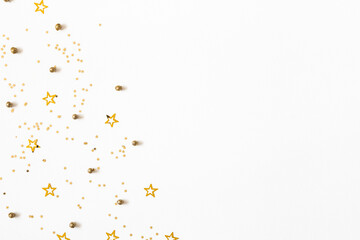 Christmas composition. Christmas golden confetti on white background. Flat lay, top view, copy space