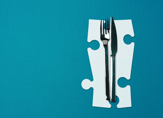 fork with knife on a blue background, top view. Table setting