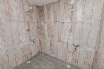 Spacious shower room with light-tiled walls