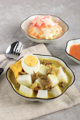 Lontong Kari Sapi or Indonesian Beef Curry with Rice Cake. Street Food Popular for Breakfast in West Java, Indonesia