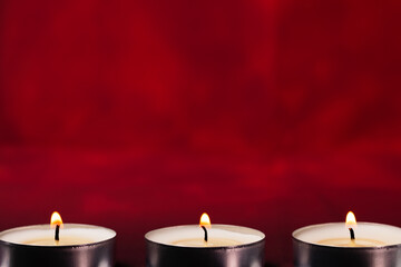 Small glowing candles on a beautiful background.