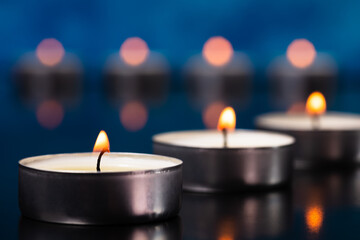 Small glowing candles on a beautiful background.