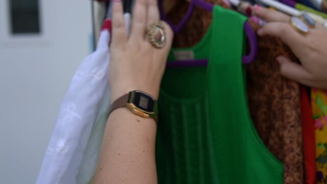 Woman shopping for clothes in flea market