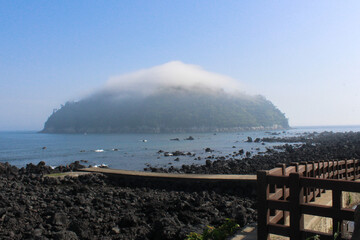 Blue ocean waves with rocks on the beach