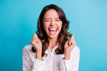 Portrait of hooray nice brunette girl hands fists wear shirt isolated on teal color background