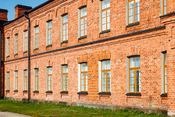 Obraz premium Beautiful vintage red brick building at sunny day
