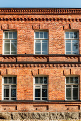 Obraz premium Beautiful vintage red brick building at sunny day