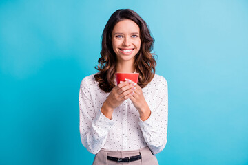 Portrait of optimistic brunette girl hold cup wear shirt isolated on teal color background