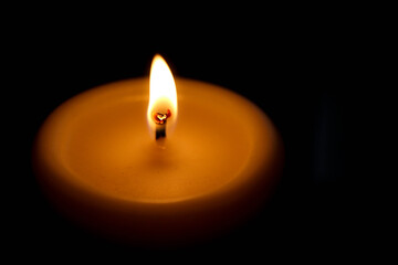 burning candle in the dark view from the top