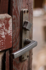 old wooden red door with a metal handle