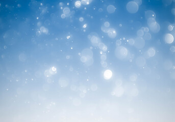 Winter snowfall and snowflakes on light blue background.blue bokeh abstract light backgrounds