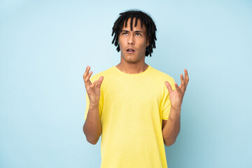 Young african american man isolated on blue background frustrated by a bad situation