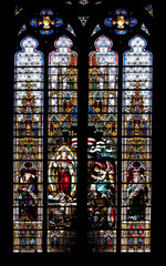 Beautiful church window with many colorful illustrations. Black background.