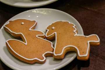 Christmas cookies on a white plate. Cookies in the form of animals. New Year's sweets. Delicious dish for children and adults.