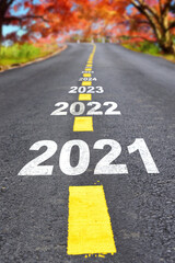 Journey to new year 2021 to 2026 on asphalt road surface with autumn season, happy new year concept