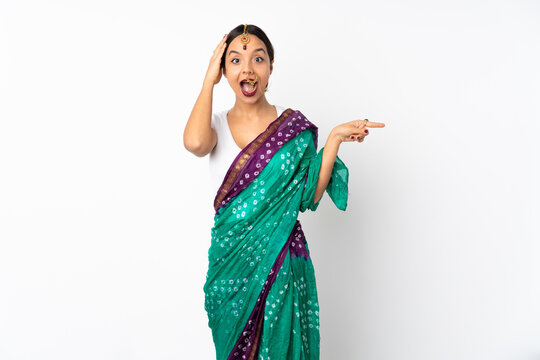 Young Indian Woman Isolated On White Background Surprised And Pointing Finger To The Side