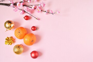 Decoration for Chinese New Year 2021 celebration. Cherry blossom branch, red, golden balls and two...