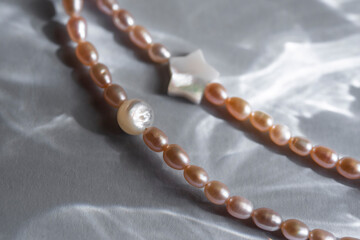 Peach pearl necklace with round and star-shaped mother of pearl