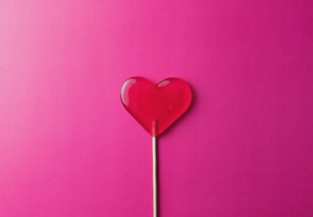 pink lollipop heart on pink background