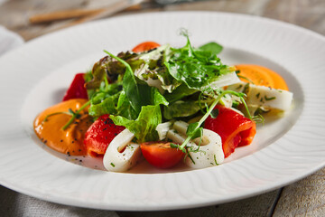 Roasted pepper salad with calamari and fresh greens