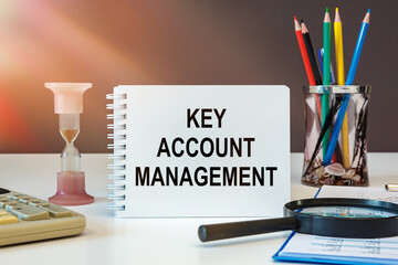 Desktop with documents, calculator and notebook. Inscription KEY ACCOUNT MANAGEMENT