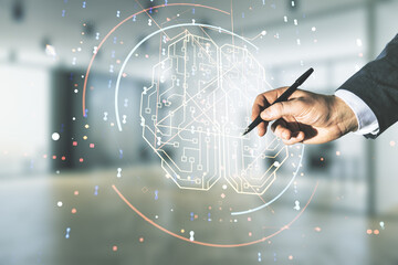 Man hand with pen working with virtual creative artificial Intelligence hologram with human brain sketch on blurred office background. Multiexposure