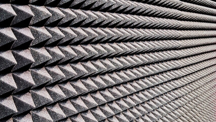Background image of recording studio sound dampening acoustical foam.