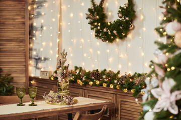 two green glasses on a wooden table. Christmas decorations