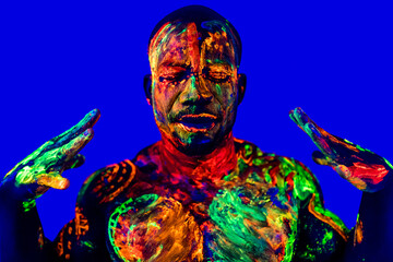 afro american man with UV body art posing in studio