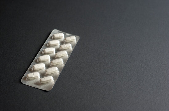 3d medicine packaging with Pills for illness and pain treatment. Medical drug package for tablet: vitamin, antibiotic, aspirin, tablets, pastils on black background.