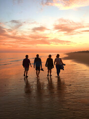 Group of friends walking at the beach during sunset © CarlosGutierrez