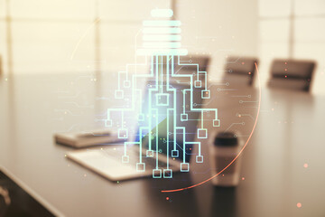 Double exposure of creative light bulb hologram with chip on laptop background, idea and brainstorming concept