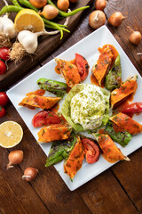 traditional turkish beyti kebab. served on a plate with salad and rice