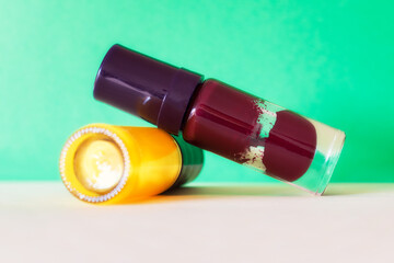 Different colors of aged and broken nail polish in selective focus. Old and dry nail varnish without labels. Hardened and dried finger nail polish bottles. PAO code and expired cosmetics concept.