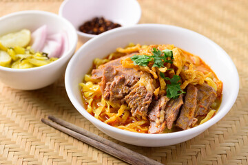 Northern Thai food (Khao Soi), Spicy curry noodles soup with beef eating with pickled mustard, shallot, lime and ground chili fried in oil