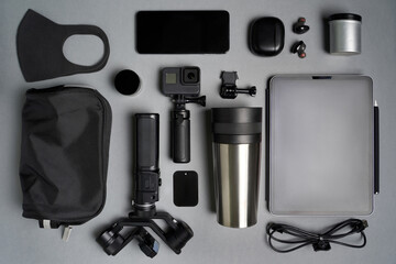 Travel or blogger kit with action camera, stabilizer, tablet, phone, earphones, mask, bag and cable. High quality photo