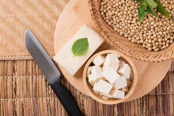 Obraz na płótnie Canvas Fresh cube tofu and soybean seeds in a bowl prepare for cooking, Asian vegan food, Top view