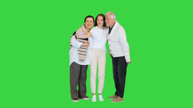 Grand dad, mother and daughter taking a selfie on a Green Screen, Chroma Key.