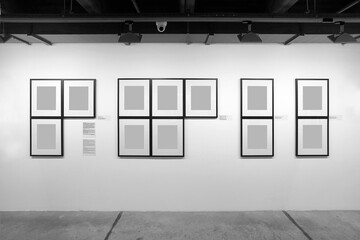 Gallery interior with empty frames on the wall. Museum and exhibition concept