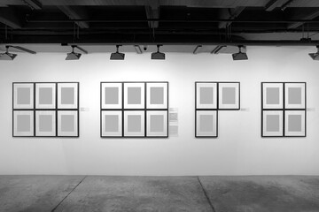 Gallery interior with empty frames on the wall. Museum and exhibition concept