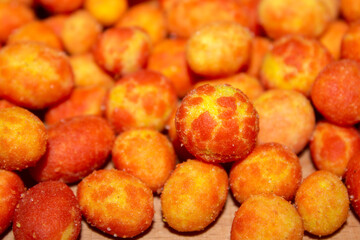 close - up on tijger nuts. A snack with double color (like tiger) and double coating on peanut with bacon and cheese aromas . selective focus