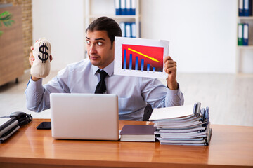 Young male sales analyst preparing financial report
