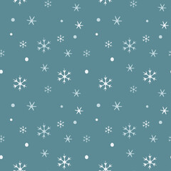 Seamless pattern with falling snowflakes on a blue background