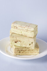 White Plate with Homemade Tasty Marshmallows with Mint and Chocolate Blue Background Vertical