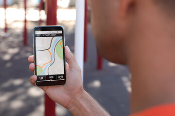 Man using fitness app on smartphone outdoors, closeup