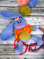 Obraz premium Handmade crochet doll, also known as amigurumi. Bunny doll with flappy ear. Children love it. Easy to make. Add colorful ribbons to make it cuter.