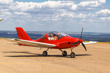 sport red plane ride. pilot and passenger in medical masks. Coronavirus, COVID-19 security and protection measures