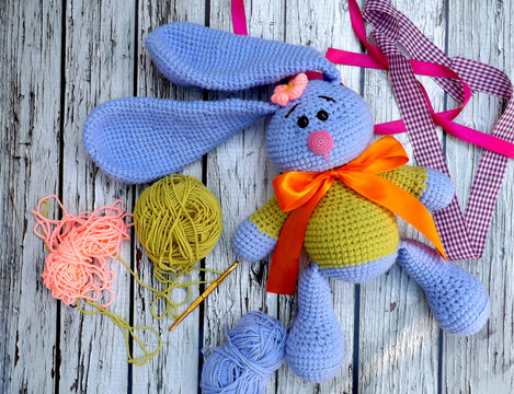 Handmade crochet doll, also known as amigurumi. Bunny doll with flappy ear. Children love it. Easy to make. Add colorful ribbons to make it cuter.