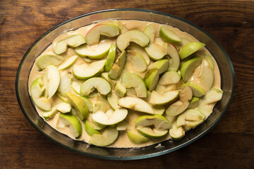 apple pie with cut apples sauce,  close up photo on a wooden table